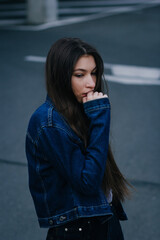 Pretty girl with long dark hair and red lips. Fashion young stylish hipster girl on street.