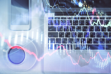 Stock market chart and top view computer on the table background. Multi exposure. Concept of financial analysis.