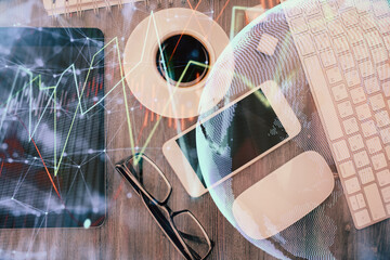 Multi exposure of forex graph hologram over desktop with phone. Top view. Mobile trade platform...