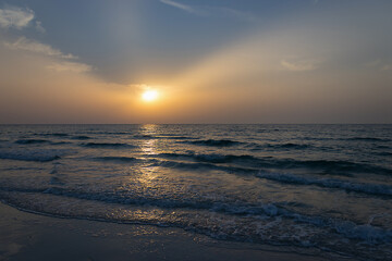 Fototapeta na wymiar Amazing sunset at the beach. Evening time. Closeup water.
