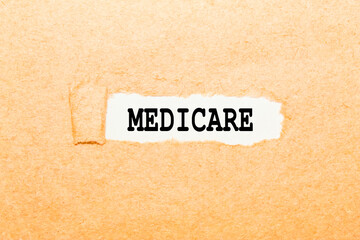 a word MEDICARE on a torn piece of paper, a business concept