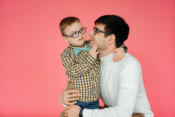 A little boy with Down Syndrome and his loving father hug each other. A loving family. Special...