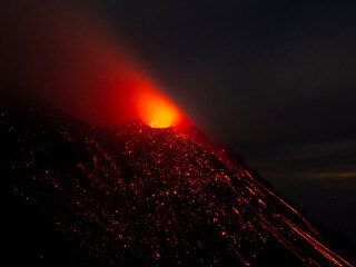 Volcano Stromboli surrounded by gleaming material after strong eruption