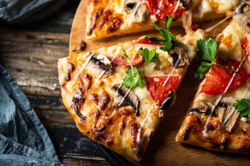 tasty juicy pizza on wooden background. lots of meat and cheese. Mushroom pizza. Pepperoni pizza. Mozzarella and tomato. Italian dish. Italian food.