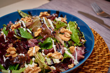 Vegan Mediterranean salad, with a mixture of lettuce, walnuts, balsamic vinegar, extra virgin olive oil, salt and mayonnaise