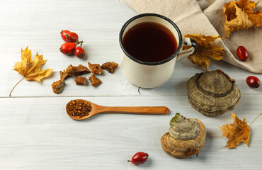 Tea made from chaga, a fungus growth that is used in alternative medicine. In an enameled travel mug close-up