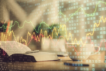 Multi exposure of forex graph drawing and desktop with coffee and items on table background. Concept of financial market trading