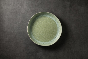 beautiful modern plate on a dark gray concrete background, top view