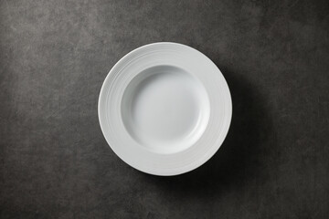 beautiful modern plate on a dark gray concrete background, top view