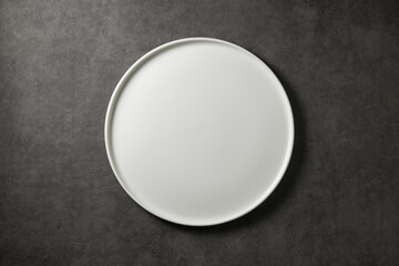 beautiful modern plate on a dark gray concrete background, top view