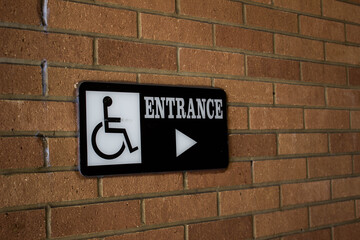 Handicap sign on brick wall