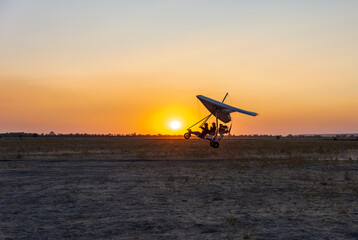 Naklejka na ściany i meble Glider flights at sunset. Evening shooting.
