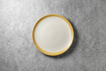 beautiful white plate on gray concrete background, top view