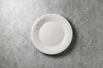 beautiful vintage plate on gray concrete background, top view
