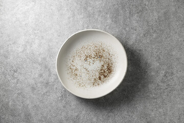 beautiful white plate on gray concrete background, top view