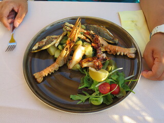 Fisch und Meeresfrüchte mit Beilagen auf einem Teller