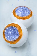 Bath bomb with sea salt crystals on a white background. High quality photo