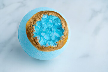 Bath bomb with sea salt crystals on a white background. High quality photo
