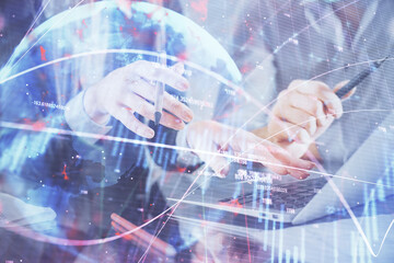 Multi exposure of man and woman working together and financial chart hologram. Business concept. Computer background.