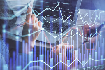 Double exposure of man and woman working together and forex chart hologram. Business concept. Computer background.