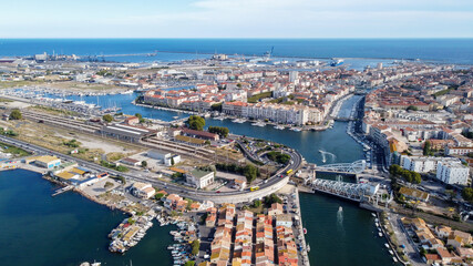 Obraz na płótnie Canvas Aerial view of the old town center of Sete in the South of France - Two urbanised islands surrounded with ancient canals between the Mediterranean Sea and the Pond of Thau