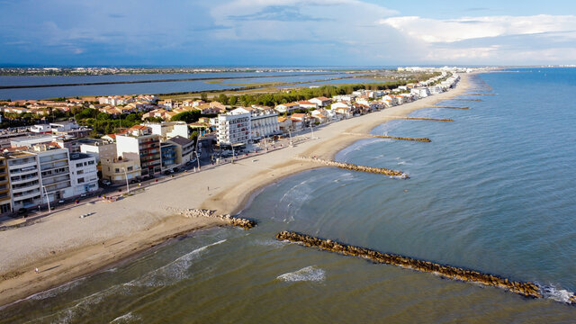 Aerial view of Palavas les Flots, a seaside resort in the South of France - Isthmus between the sandy beach of the Mediterranean Sea and the Pond of Perols with residential buildings