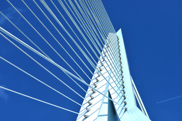 Multiple strings of a bridge abutment against blue sky