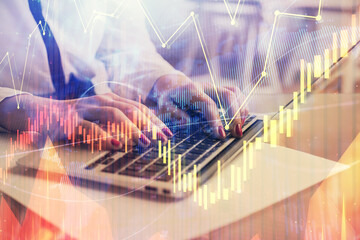 Multi exposure of woman hands typing on computer and financial graph hologram drawing. Stock market analysis concept.