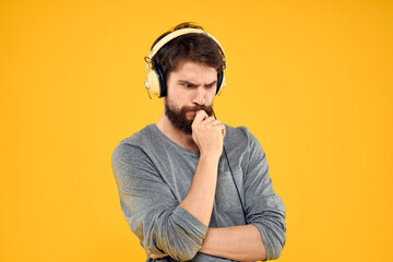 Man with headphones music lifestyle lifestyle technology yellow background