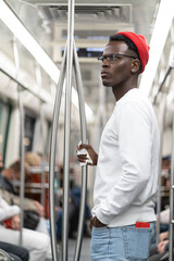 Afro American man in red hat does not want to wear a face mask in public transportation during...