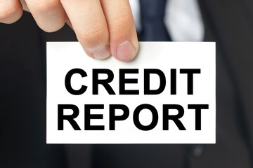 Businessman shows a card with the text - CREDIT REPORT