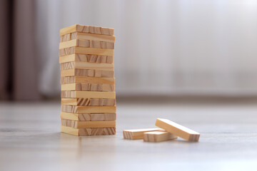 a tower of wooden blocks on the floor