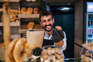 Handsome middle age male worker working in bakery.