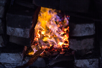 In a blacksmith's workshop. The metal billet is held in a coal flame in a furnace. An example of the hard work of ancient crafts.