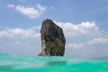 Fototapeta premium rock in the Andaman Sea against cloudy blue skies, Thailand