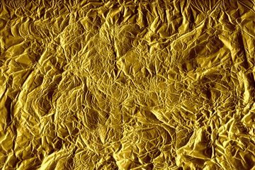Gold shiny wall abstract background. Crumpled luxury metallic foil texture.