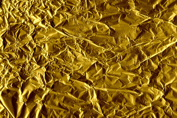 Gold shiny wall abstract background. Crumpled luxury metallic foil texture.