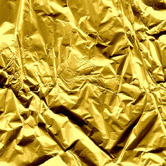 Gold shiny wall abstract background. Crumpled luxury metallic foil texture.