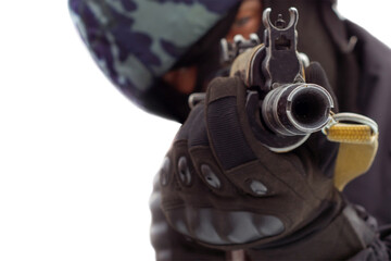 Obraz premium military man holding a gun and aiming. The sniper aims and shoots.