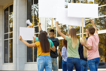 Group of people protesting outdoors, back view
