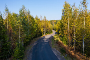 Fototapeta premium Aerial view of the road in the autumn forest in Karelia