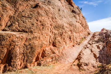 red rock formation with trail