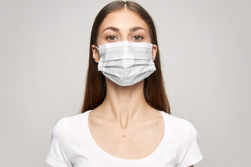 Pretty woman medical face mask look ahead close-up white t-shirt 