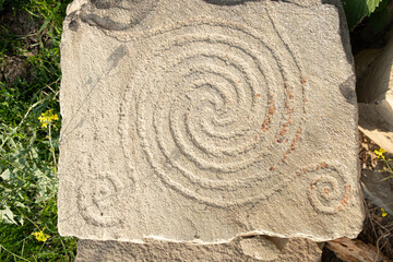 Ancient petroglyphs on the stone walls of an old house, drawings on stones Russia Dagestan
