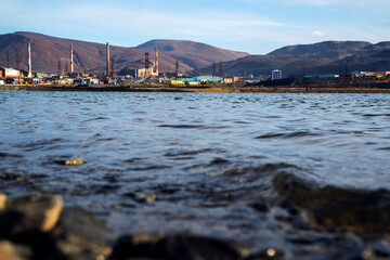 Polluted lake shore in the city of Norilsk. Environmental pollution.