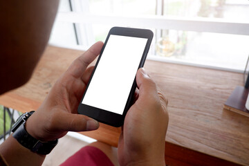 Mockup picture of business woman’s hands/man's hands holding smart phone with white blank screen in modern place.
