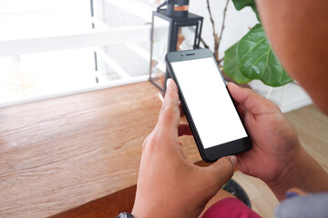 Mockup picture of business woman’s hands/man's hands holding smart phone with white blank screen in modern place.
