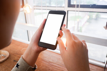 Mockup picture of business woman’s hands/man's hands holding smart phone with white blank screen in modern place.