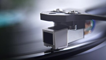 Close up of stylus or needle on turntable with vinyl record spinning