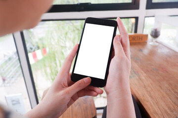 Mockup picture of business woman’s hands/man's hands holding smart phone with white blank screen in modern place.